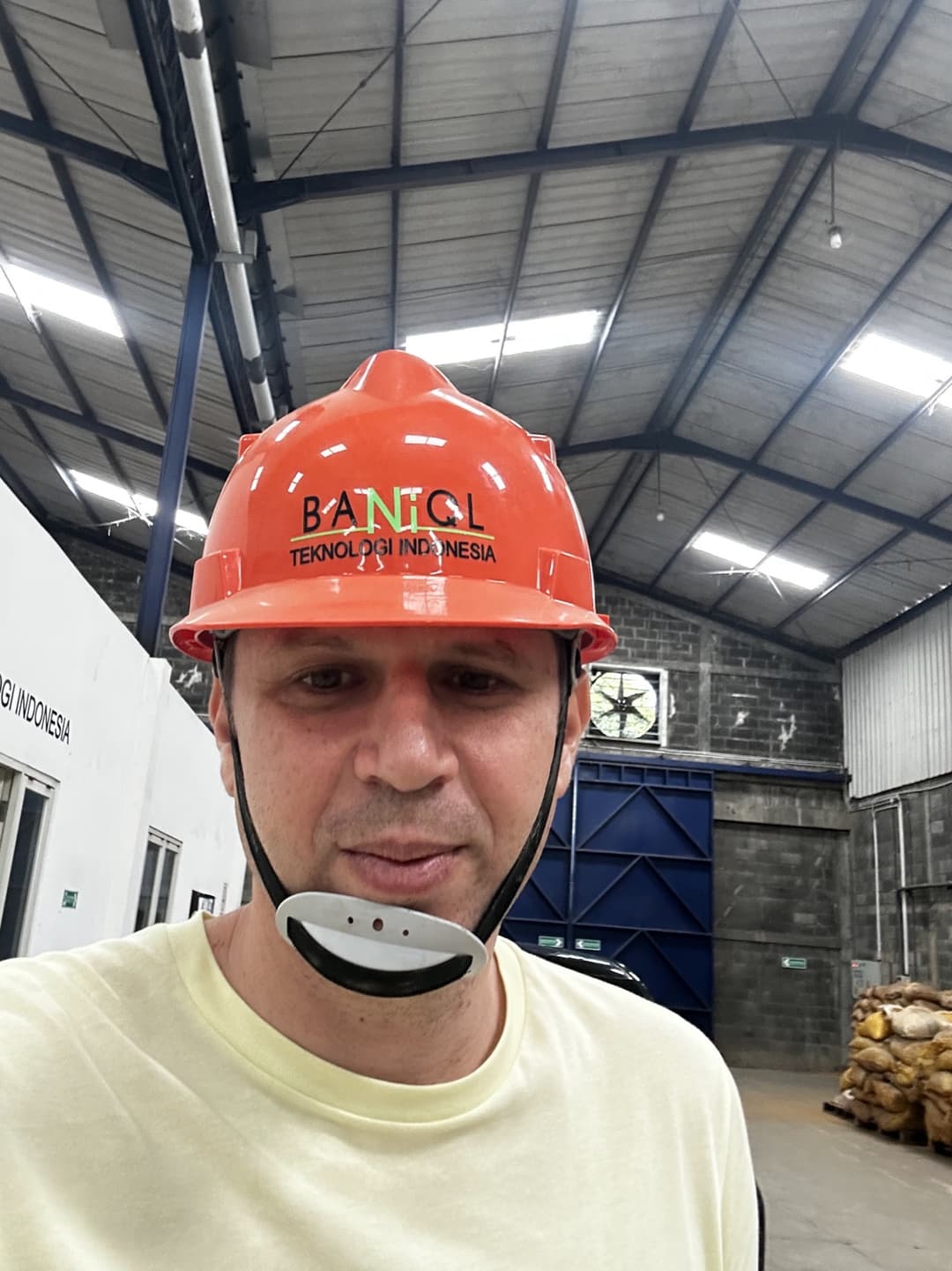 Alex in a Baniql hard hat at the factory in Indonesia