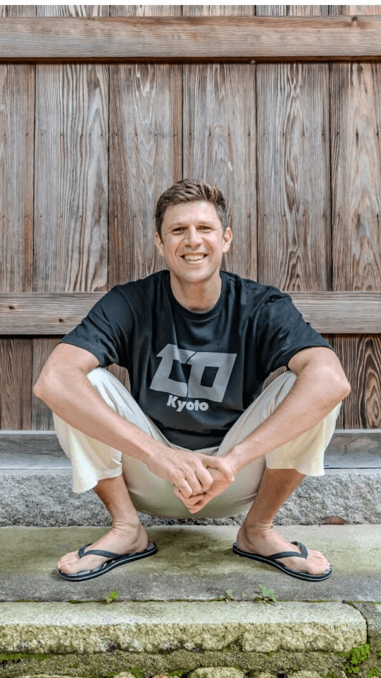 Alex Miller sitting on a temple step in Kyoto