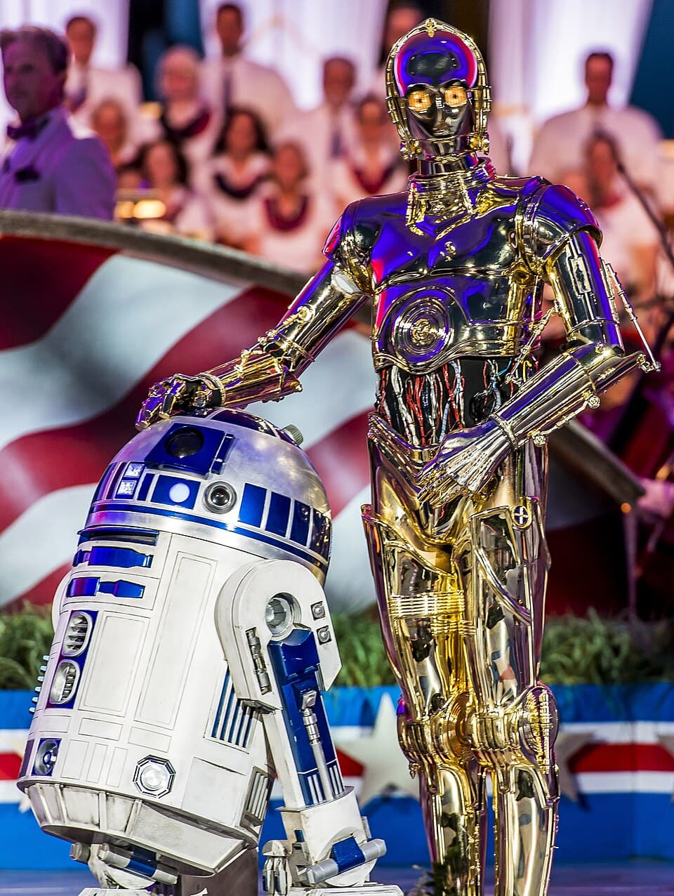 R2-D2 and C-3PO, the droids from Star Wars, standing together on stage