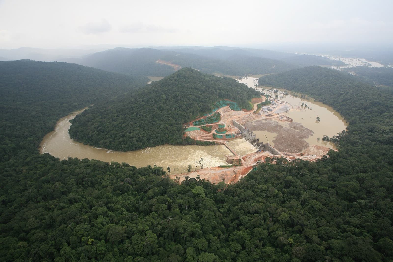 Aerial view of the Nam Theun 2 hydropower dam across a river bend in the Lao jungle