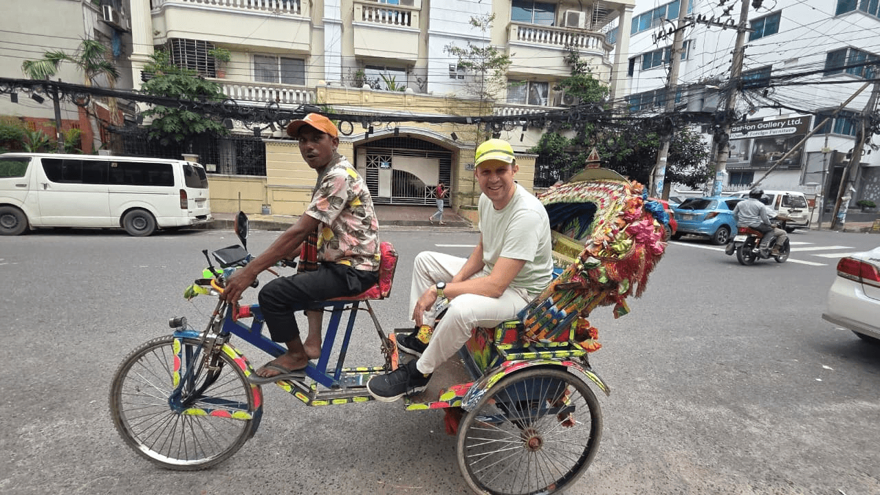 A decorated cycle-rickshaw on a Dhaka street — the Bangla Tesla
