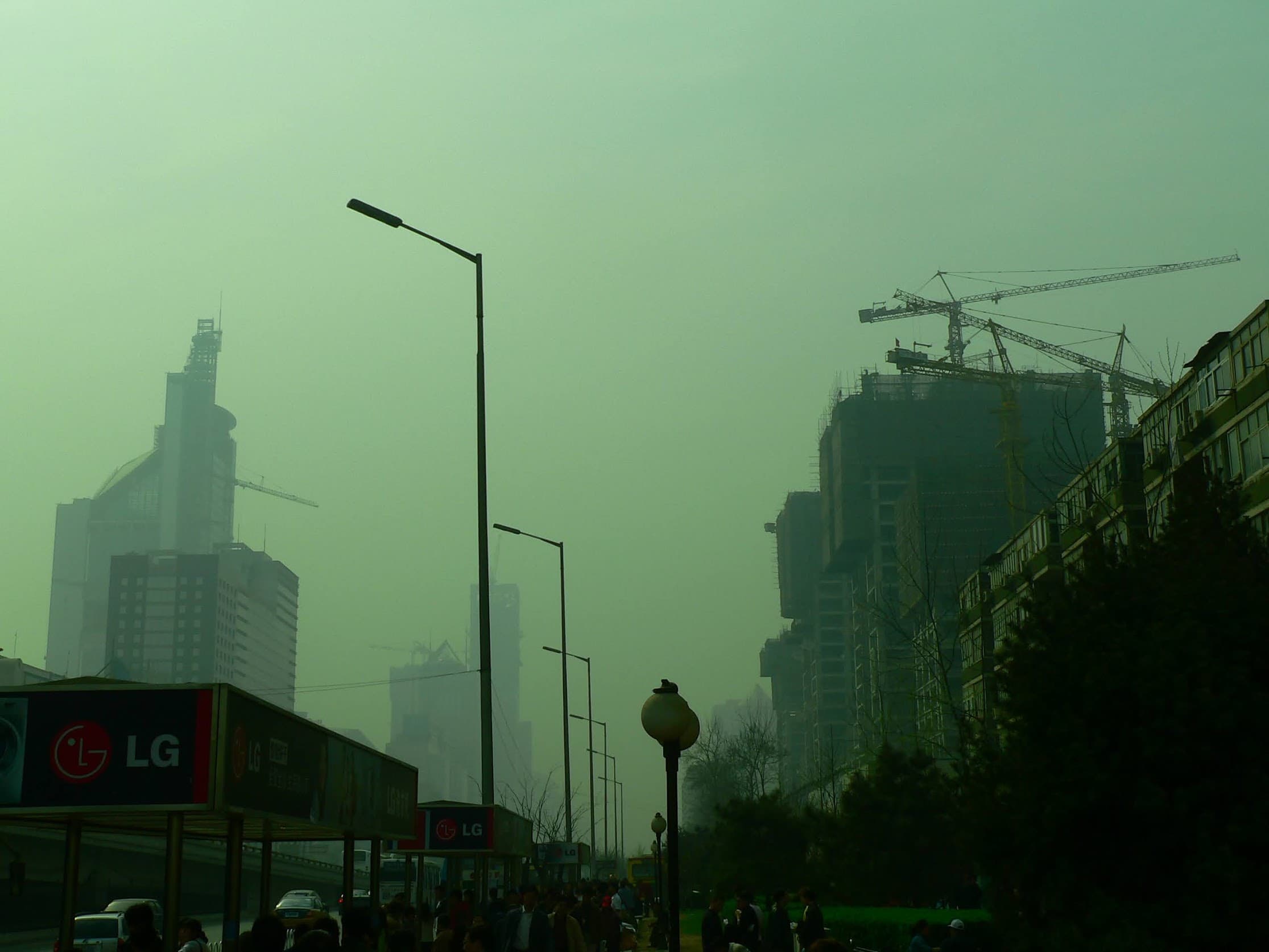 Beijing skyline under heavy smog with construction cranes, 2006